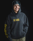 Person wearing a black hoodie with 'BE GOOD.' text on a black background