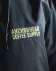Black jacket with 'Anchorhead Coffee Supply' text in yellow on a dark background