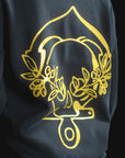 Black sweatshirt with gold floral design on a black background