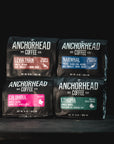 Four Anchorhead Coffee packages on a black background