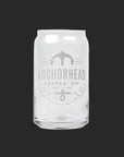 Clear glass resembling a soda can with "Anchorhead Coffee Co" and an anchor logo printed in white. Minimalistic design on a dark gray background.